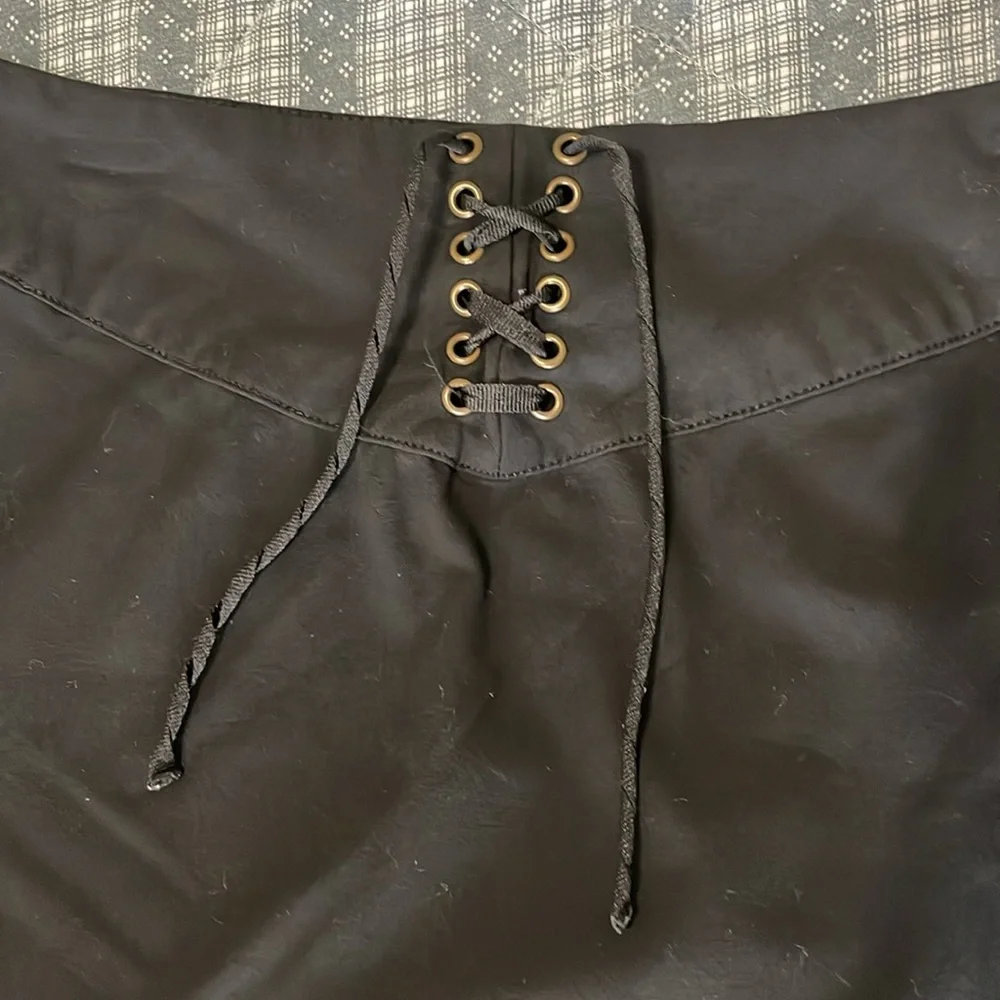 Women’s size 6, black pencil skirt stretchy. Lattice lace up. Hidden side zipper
